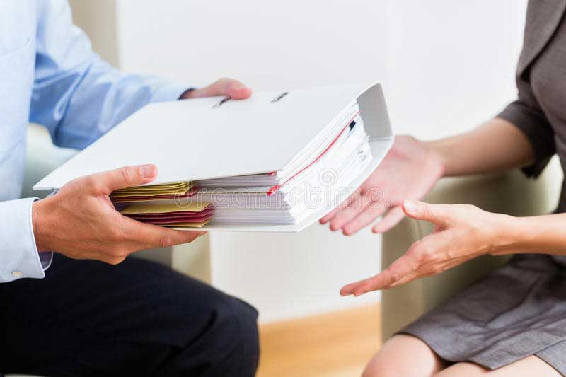 financial consulting customer handing over documents to consultant further analysis 66242648